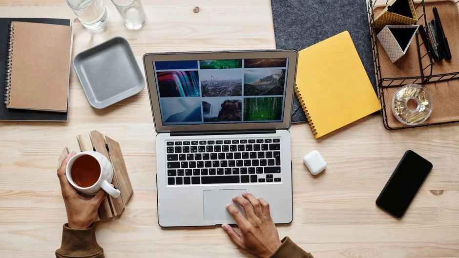 A modern workspace with a smartphone displaying a screen and a computer setup, ideal for business and technology themes.